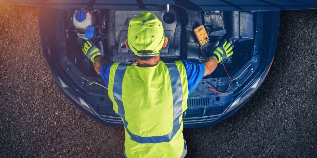 Mechanic inspecting a car engine.